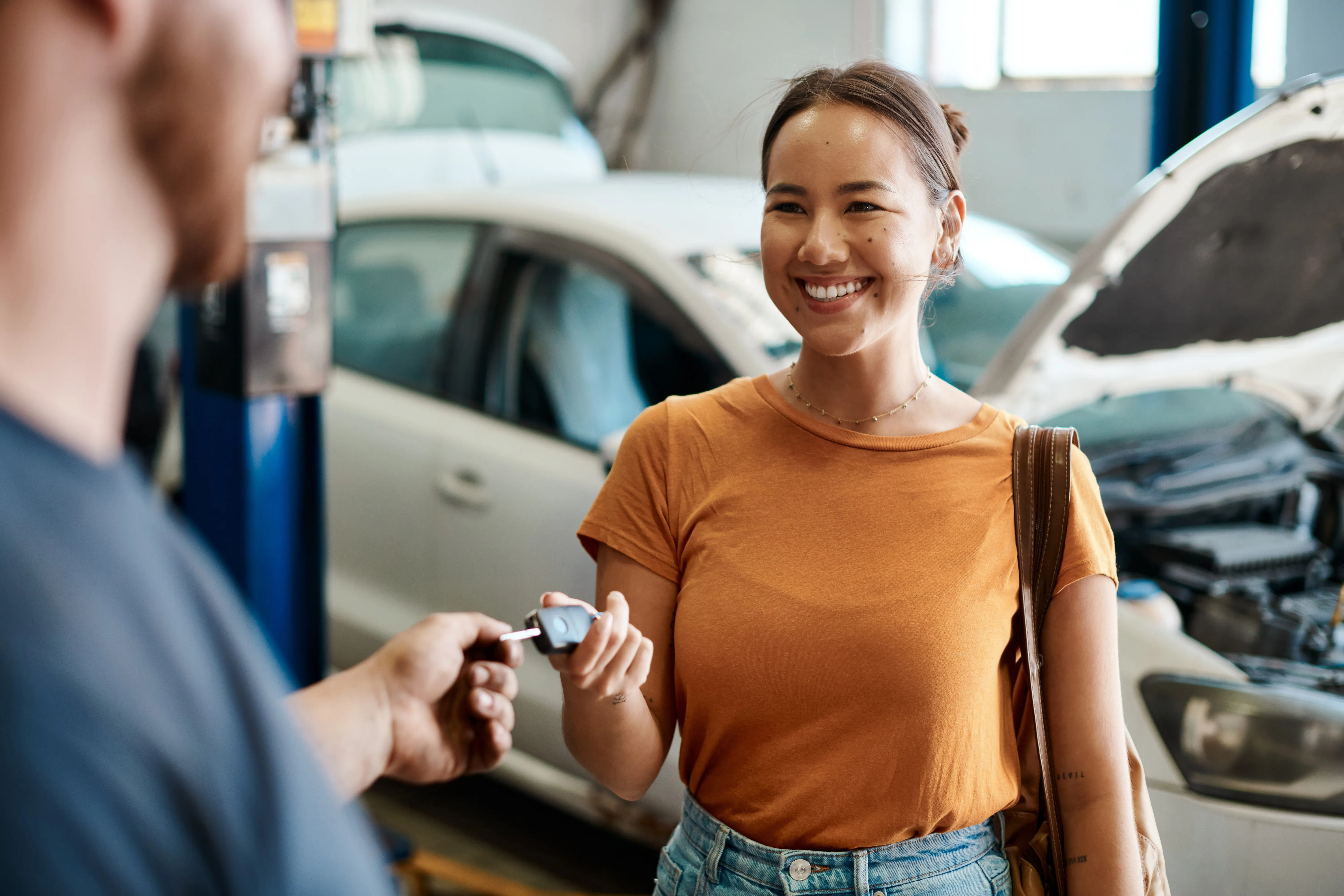 We take care of cars and the people who drive them. Shot of a woman receiving her car keys.